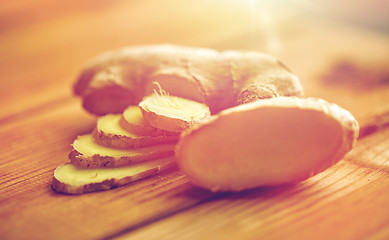 Image showing close up of ginger root on wooden table