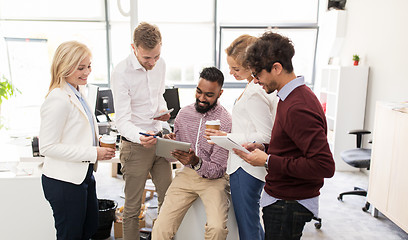 Image showing business team with tablet pc and coffee at office