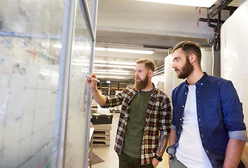 Image showing men writing on whiteboard at brewery or beer plant