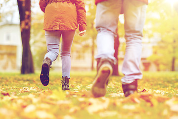 Image showing young couple running in autumn park