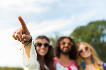 Image showing happy hippie woman pointing finger outdoors