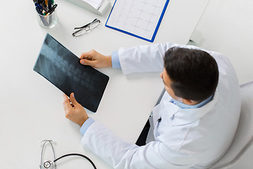 Image showing doctor with spine x-ray sitting at table