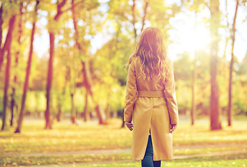 Image showing beautiful young woman walking in autumn park