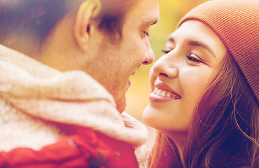 Image showing close up of happy young couple kissing outdoors