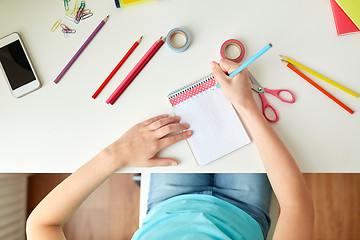 Image showing girl drawing in notebook at home