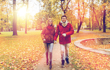 Image showing happy young couple running in autumn park