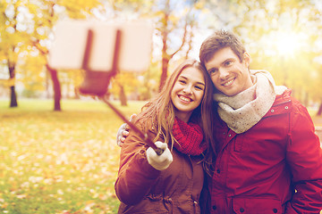 Image showing couple taking selfie by smartphone in autumn park