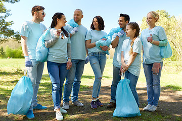 Image showing group of volunteers with garbage bags in park