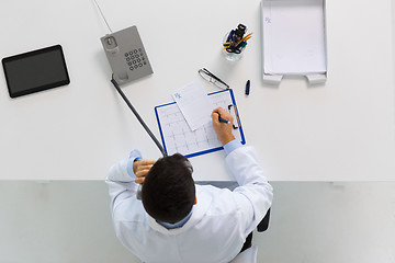 Image showing doctor with prescription calling on phone