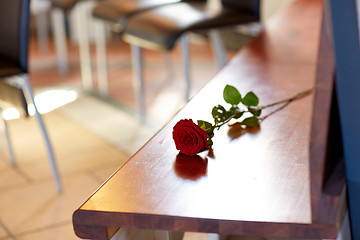 Image showing red roses on bench at funeral in church