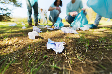 Image showing volunteers with garbage bags cleaning park area