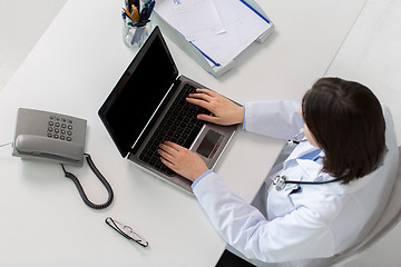 Image showing woman doctor typing on laptop at clinic