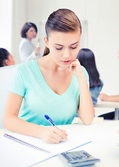 Image showing student girl with notebook and calculator