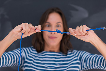 Image showing woman holding a internet cable in front of chalk drawing board