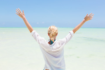 Image showing Happy woman enjoying, relaxing joyfully in summer on tropical beach.