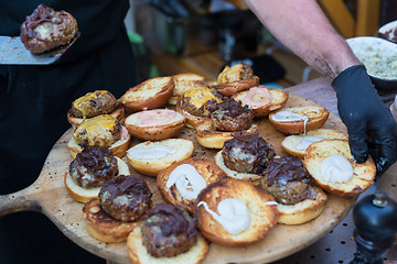 Image showing Chef making beef burgers outdoor on open kitchen international food festival event.