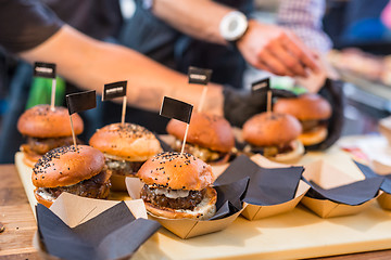 Image showing Chef making beef burgers outdoor on open kitchen international food festival event.