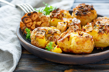 Image showing Baked potatoes with spices, olive oil and garlic.