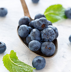 Image showing Ripe blueberries in a tablespoon of closeup.