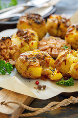 Image showing Potatoes baked in their skins with spices.