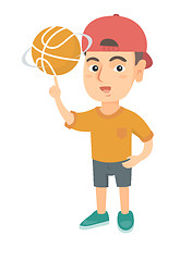 Image showing Caucasian boy spinning basketball ball on finger.