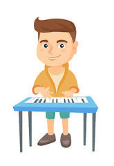 Image showing Little caucasian boy playing the piano.