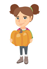 Image showing Caucasian girl standing with a big orange pumpkin.