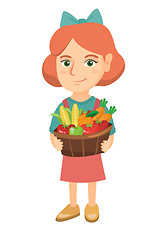 Image showing Girl holding basket with fruit and vegetables.