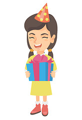Image showing Caucasian girl in birthday cap holding gift box.