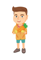 Image showing Caucasian boy holding fresh carrot.