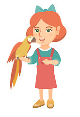 Image showing Caucasian little girl holding parrot on her hand.