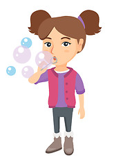 Image showing Little caucasian girl blowing soap bubbles.