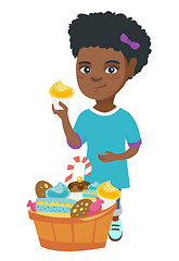 Image showing Girl holding a cupcake and stroking her belly.