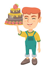 Image showing Little caucasian boy holding a chocolate cake.