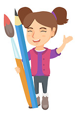 Image showing Smiling girl holding big pencil and paintbrush.