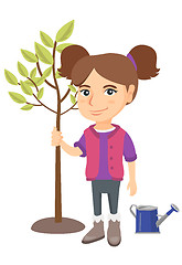 Image showing Caucasian smiling girl planting a tree.