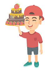 Image showing Little caucasian boy holding a chocolate cake.