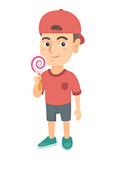 Image showing Little caucasian boy holding a lollipop candy.