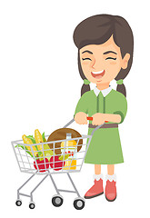 Image showing Little caucasian girl with her shopping trolley.