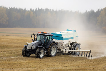 Image showing Tractor Spreads Agrilime on Foggy Day 