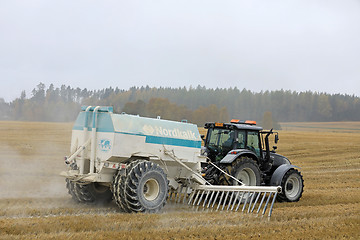 Image showing Spreading Agricultural Lime on Stubble Field in Autumn