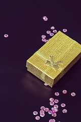 Image showing Gold christmas gift box and pink sequins, retro toned