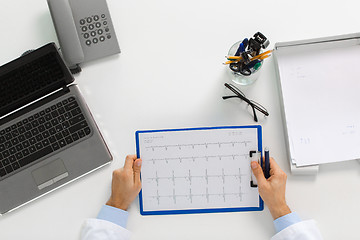 Image showing doctor hands with cardiogram and laptop at clinic