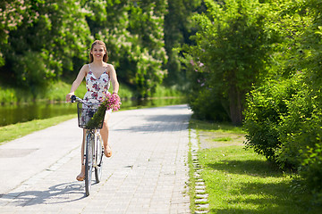 Image showing happy woman riding fixie bicycle in summer park