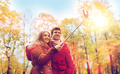 Image showing couple taking selfie by smartphone in autumn park