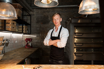 Image showing chef or baker in apron at bakery kitchen