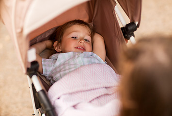 Image showing little child or baby lying in stroller outdoors