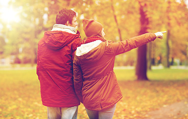 Image showing happy young couple walking in autumn park