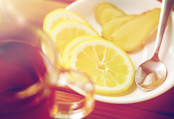 Image showing tea cup with lemon and ginger on plate
