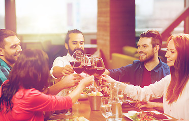 Image showing friends dining and drinking wine at restaurant